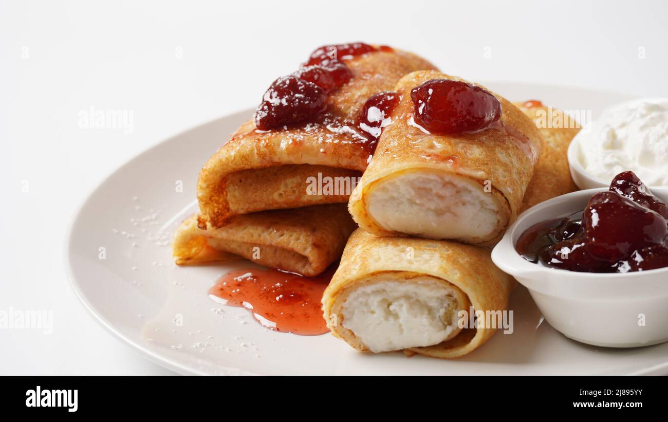 Pancakes with sweet cottage cheese and strawberry jam for breakfast