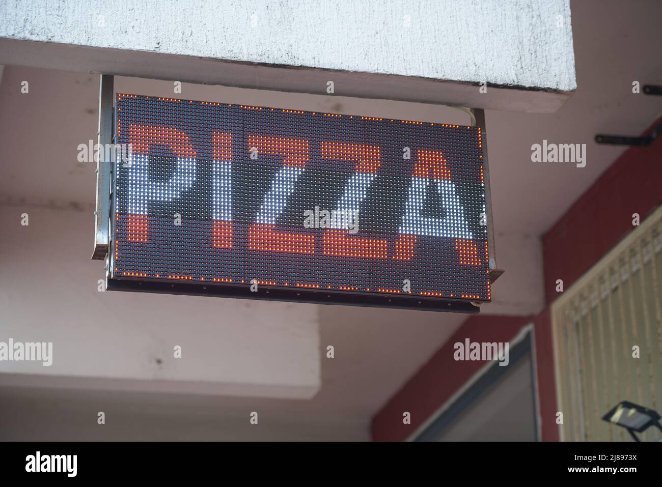 Pizza LED sign on the street for advertising Stock Photo