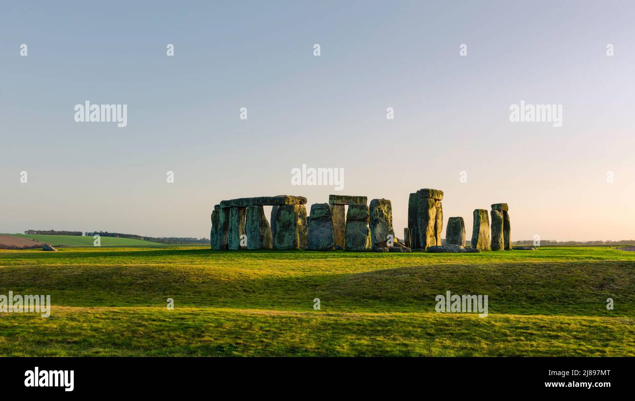 Stonehenge, prehistoric standing stones surrounded by grassland bathed in fading spring light at dusk. Amesbury, Wiltshire, UK. Stock Photo