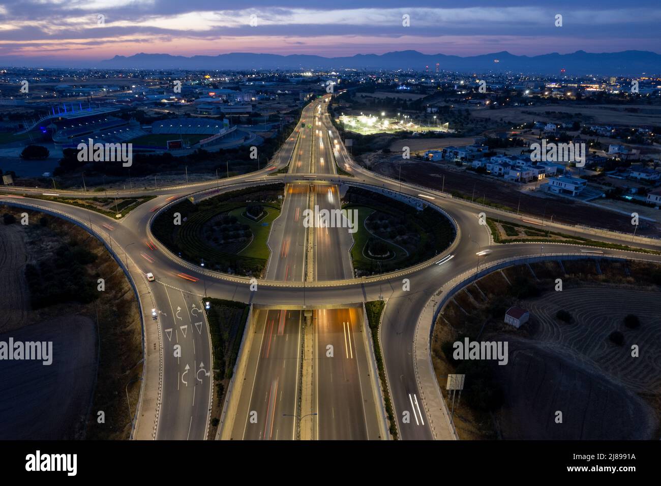 Aerial drone view of highway junction. Roundabout cars moving fast. Transportation infrastructure Stock Photo