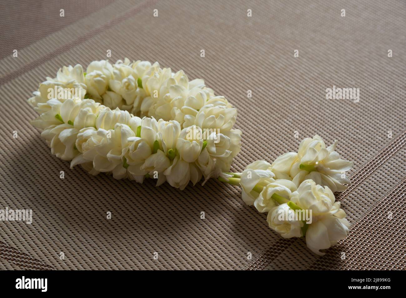 Close-up view of beautiful jasmine garland on the table. Stock Photo