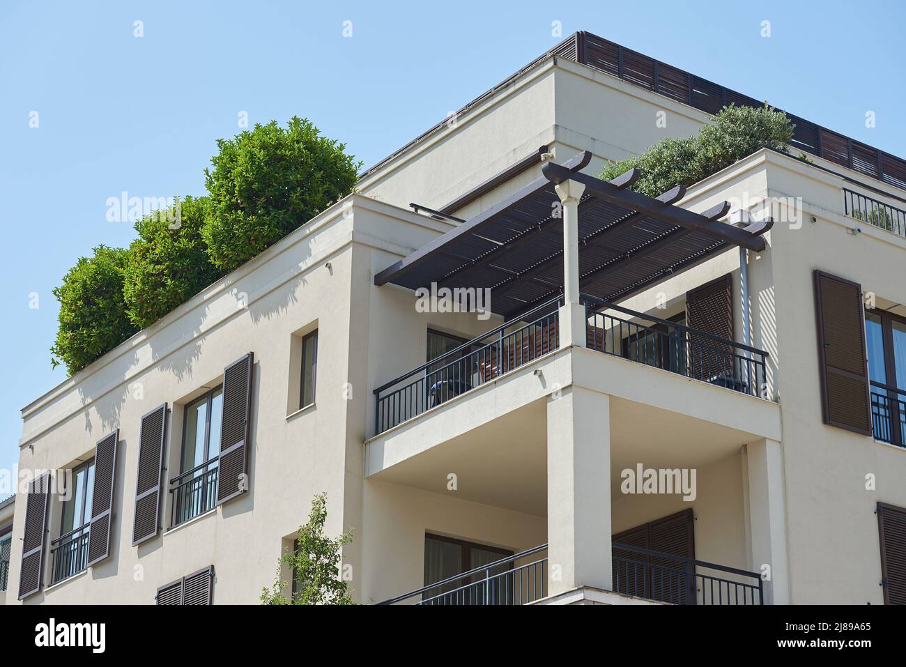 Balcony with pergola roof in a modern house in Europe Stock Photo