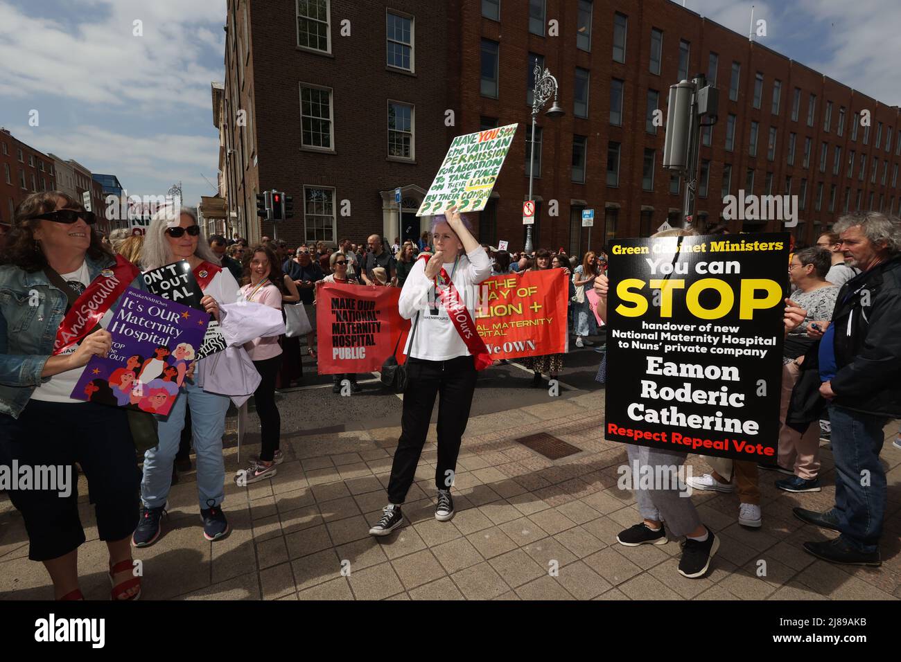 People take part in a protest outside Leinster House in Dublin, Ireland