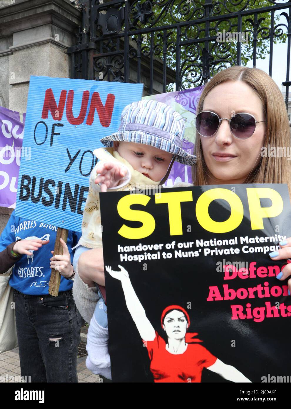 People take part in a protest outside Leinster House in Dublin, Ireland against the ownership