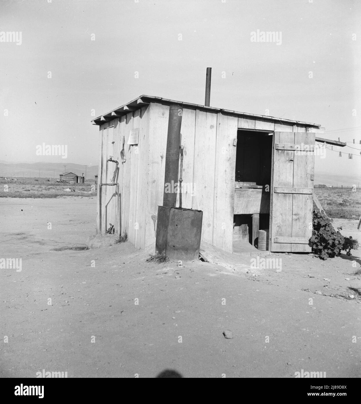 Laundry facilities for ten cabins at Arkansawyers auto camp, Salinas Valley, California. Note stove to heat water. Stock Photo