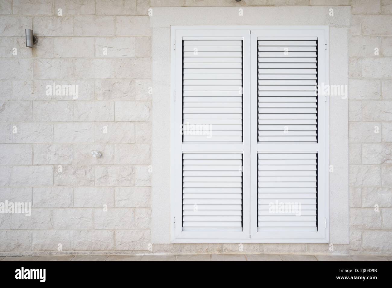 Plastic external window shutters on a residential building Stock Photo ...