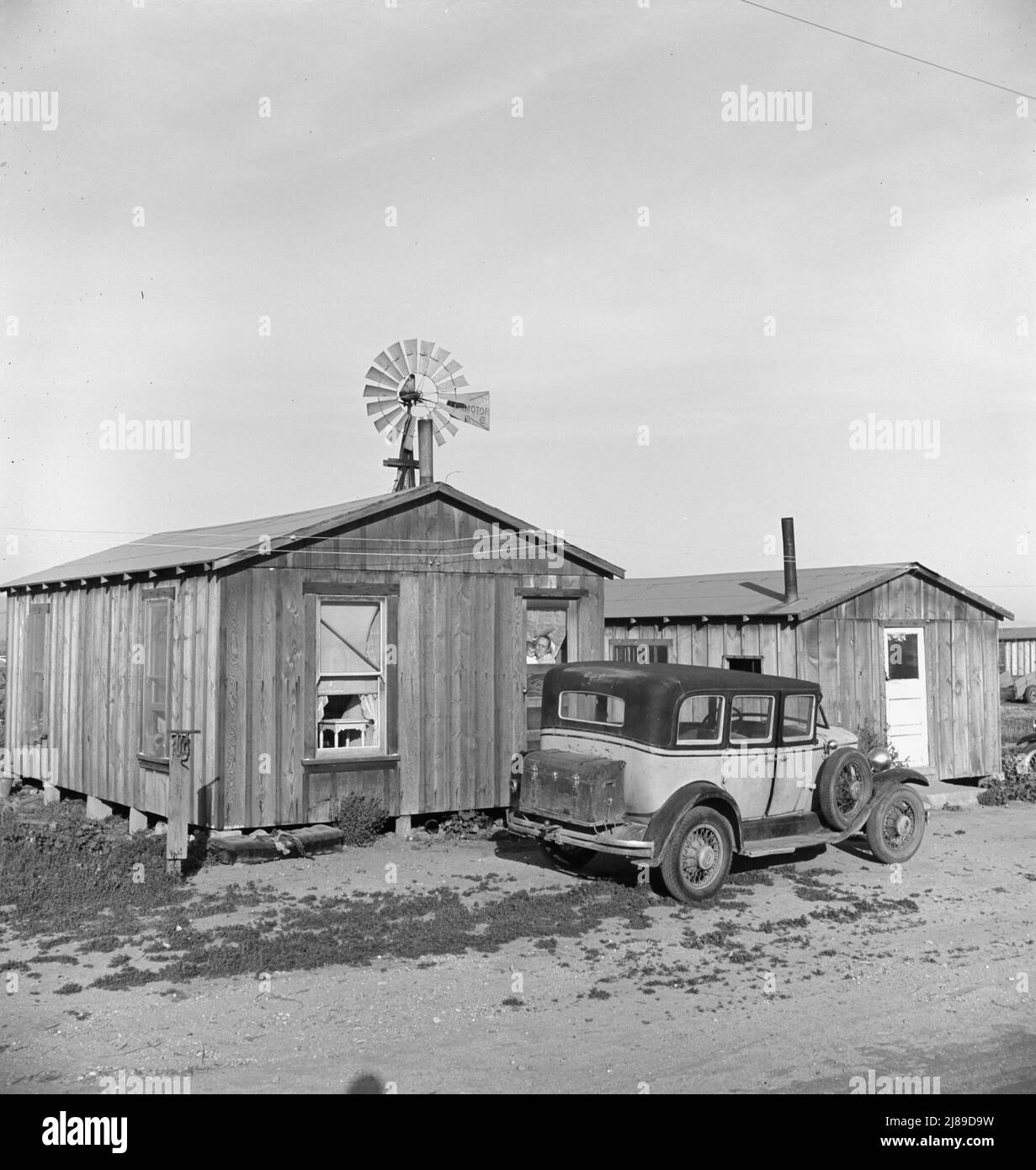 Cabins which rent for ten dollars a month. Includes iron bed and electric lights. In Arkansawyers auto camp. Greenfield, Salinas Valley, California. [Very basic accommodation for farm workers from the state of Arkansas]. Stock Photo