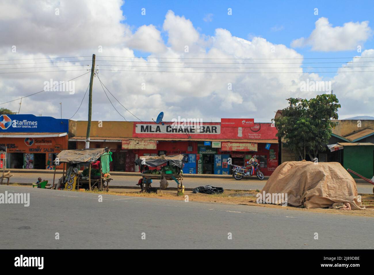Roadside shops stalls along road in Kenyan village. Kenya, Africa Stock Photo