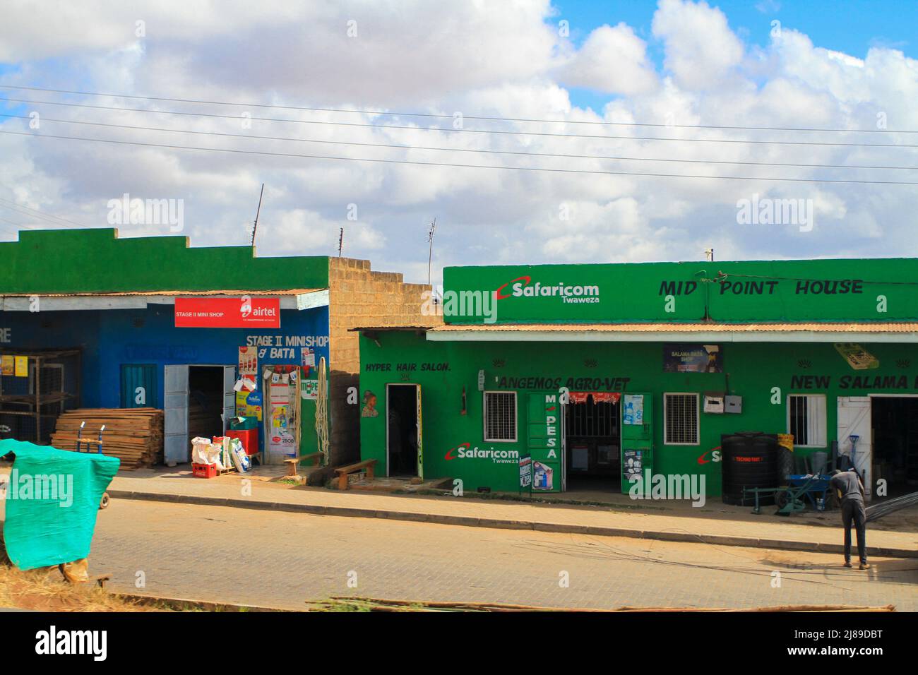 Safaricom and Airtel shops in Kenyan village. Mobile internet technology and MPesa providers. Unrecognizable unrecognisable person. Kenya, Africa Stock Photo