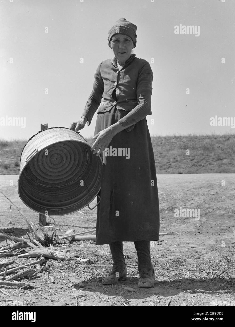 A grandmother in a contractor's camp. Stanislaus County, California. &quot;Been in California fourteen months from Oklahoma. The main thing is to get our families located and quieted down. Ain't no use to send them back; it's a waste of money. They won't stay.&quot;. Stock Photo