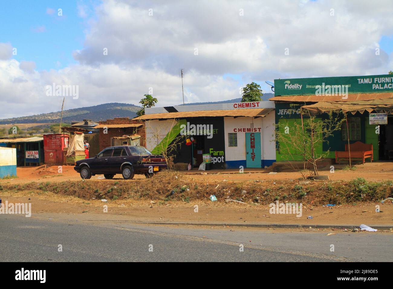 Chemist shop or pharmacy among small shops in Kenyan village. Kenya Stock Photo