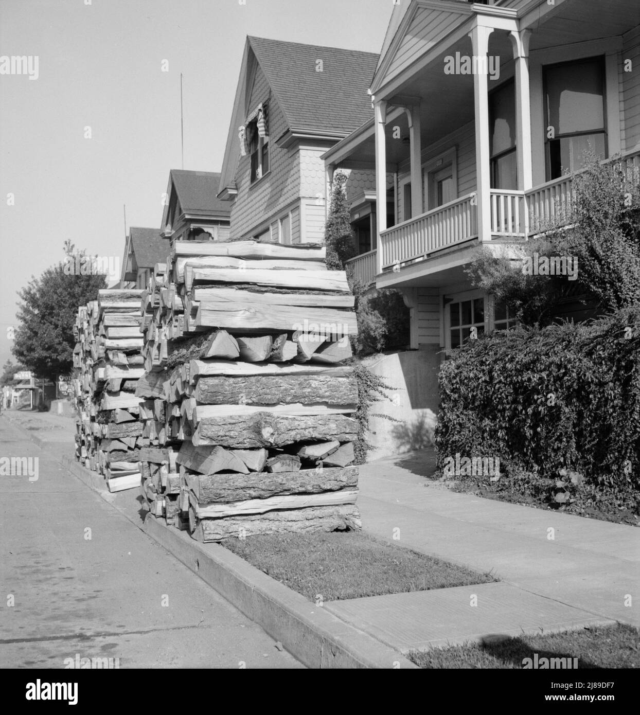 Woodpiles along the street are a characteristic of Portland, Oregon. Costs five dollars and fifty cents per cord, and must now be hauled thirty-five miles. Portland, Oregon. Stock Photo