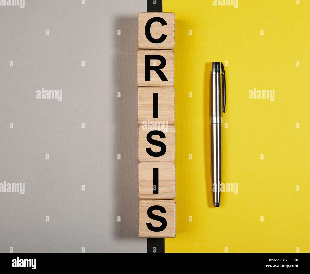 Crisis word on gray yellow background. Good and bad affects. High quality photo Stock Photo