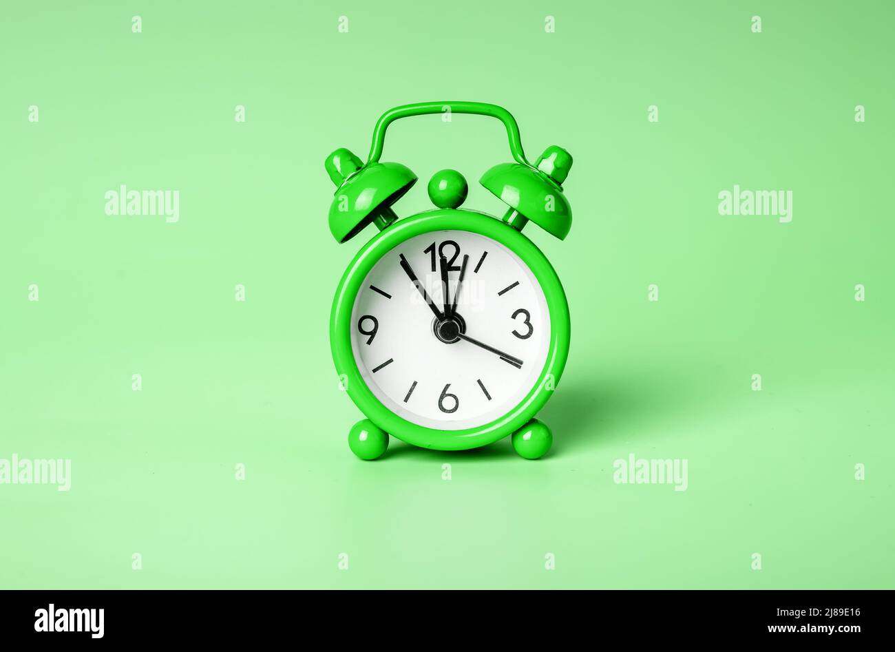Retro green alarm clock on eco background. High quality photo Stock Photo