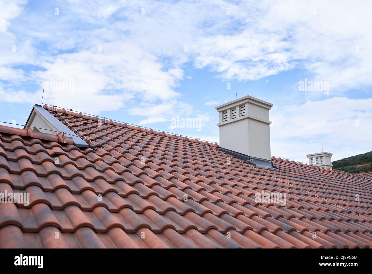Roof made of modern polymer tiles against the blue sky Stock Photo