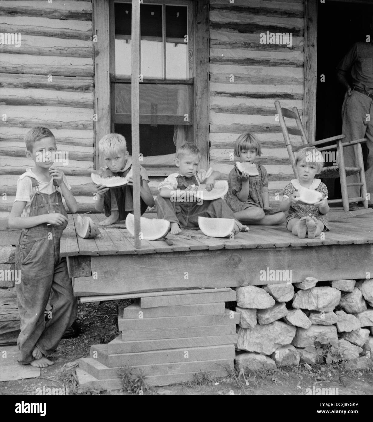 Millworker's children eating watermelon on porch of rented house. Six