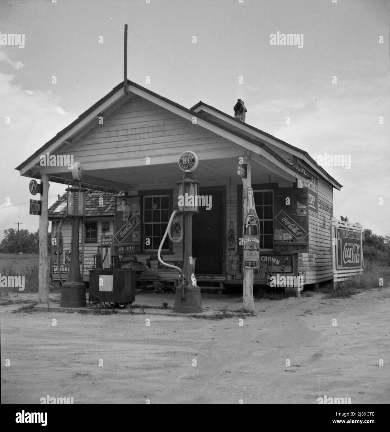 Country filling station owned and operated by tobacco farmer. Such small independent stations have become meeting places and loafing spots for neighborhood farmers in their off times. Granville County, North Carolina. Stock Photo