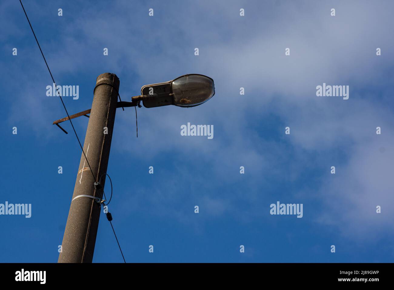 Old street lighting lantern against the sky. Background for design