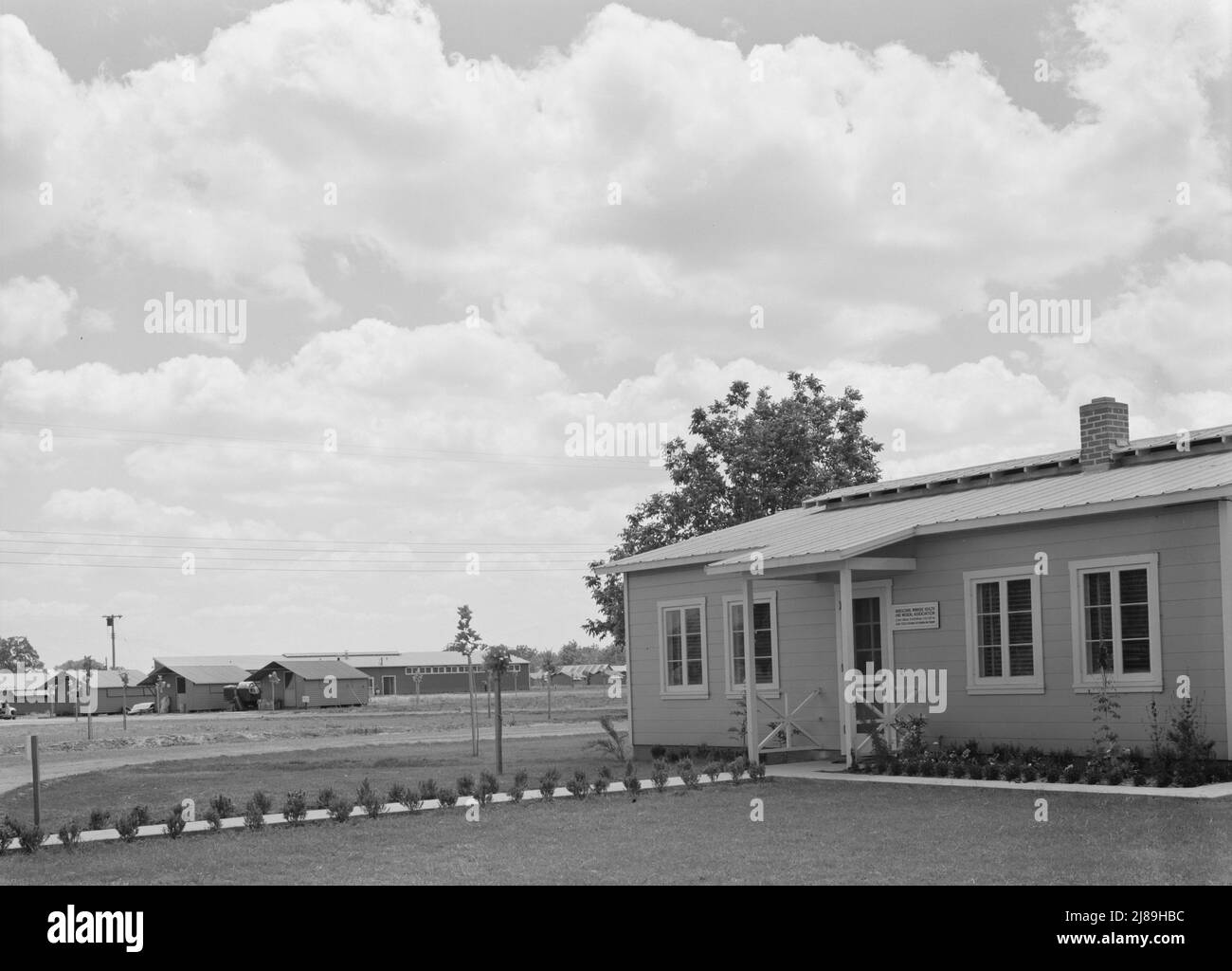 Tulare County, California. Farm Security Administration (FSA) camp for migratory agricultural workers. View of camp, showing clinic in foreground. [Sign: 'Agricultural Workers Health and Medical Association']. Stock Photo
