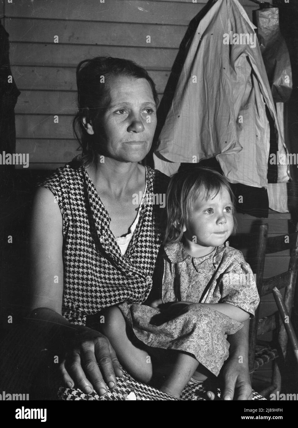 Tulare County. Farm Security Administration camp (FSA) for migratory agricultural workers at Farmersville. Mother and child, come to California from Oklahoma. They have six children, aged two to nineteen years. The mother finished the eighth grade in school. They left their farming in Chicasha in the fall of 1936 to go to Arizona to pick cotton. They returned to Oklahoma to try again; failed and re-entered California February 27, 1938 to pick peas under a labor contractor. The father is chairman of camp council. Stock Photo