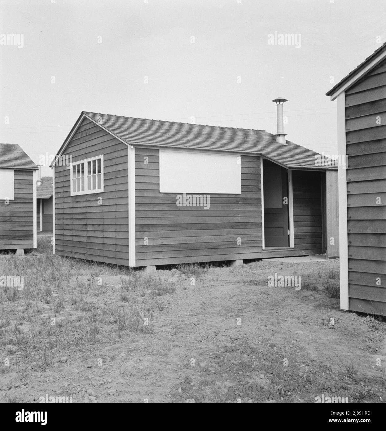 Shows new type of wooden shelter for migratory workers. FSA (Farm Security Administration) camp. Near McMinnville, Oregon. General caption number 60. Stock Photo