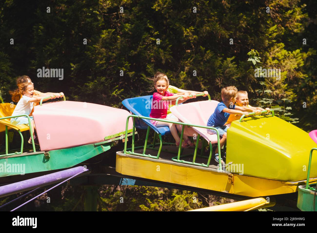 The confused kids ride a roller coasters for the first time Stock Photo