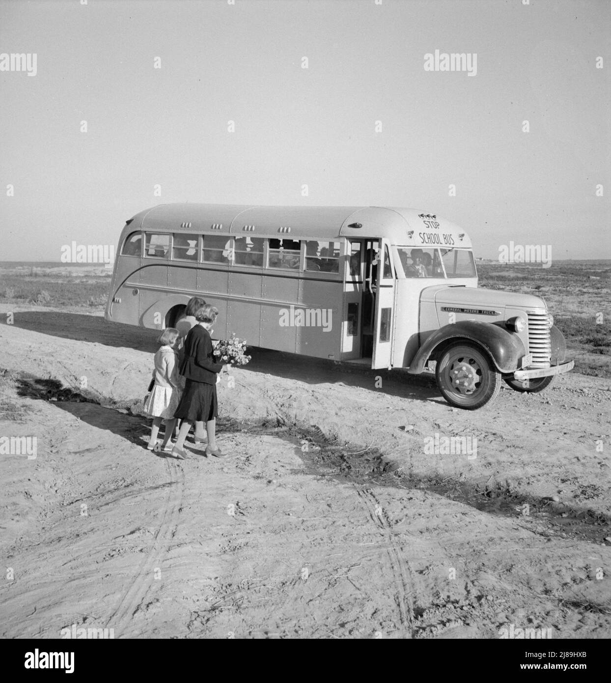 Dead Ox Flat. Children get into school bus on a fall morning. Malheur County, Oregon. Stock Photo