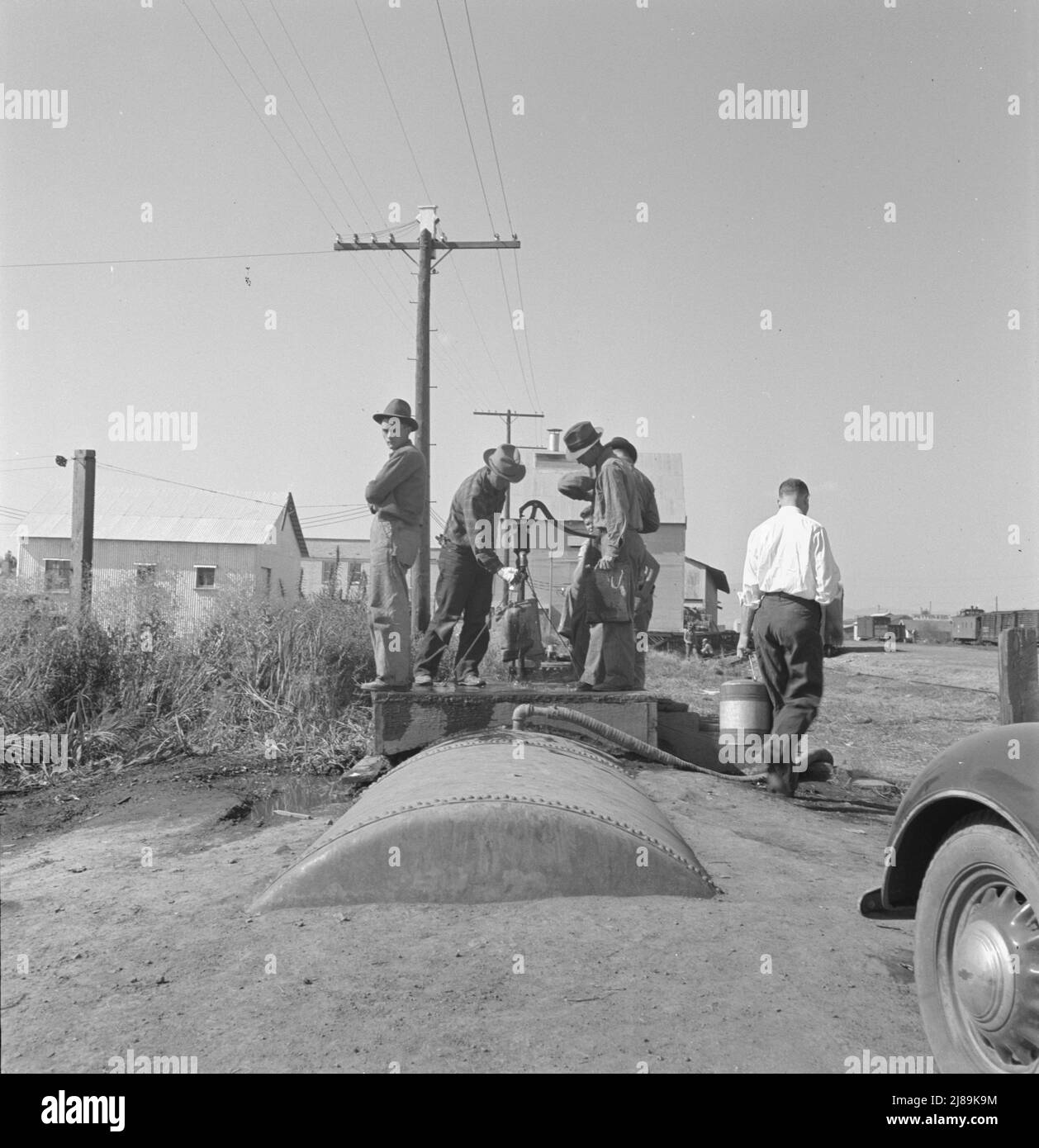 Town pump of Tulelake at railroad yard. Tulelake, Siskiyou County, California. Over 1500 people depend on hauled water for drinking the year round. During potato harvest, this pump also serves the migratory pickers. Stock Photo