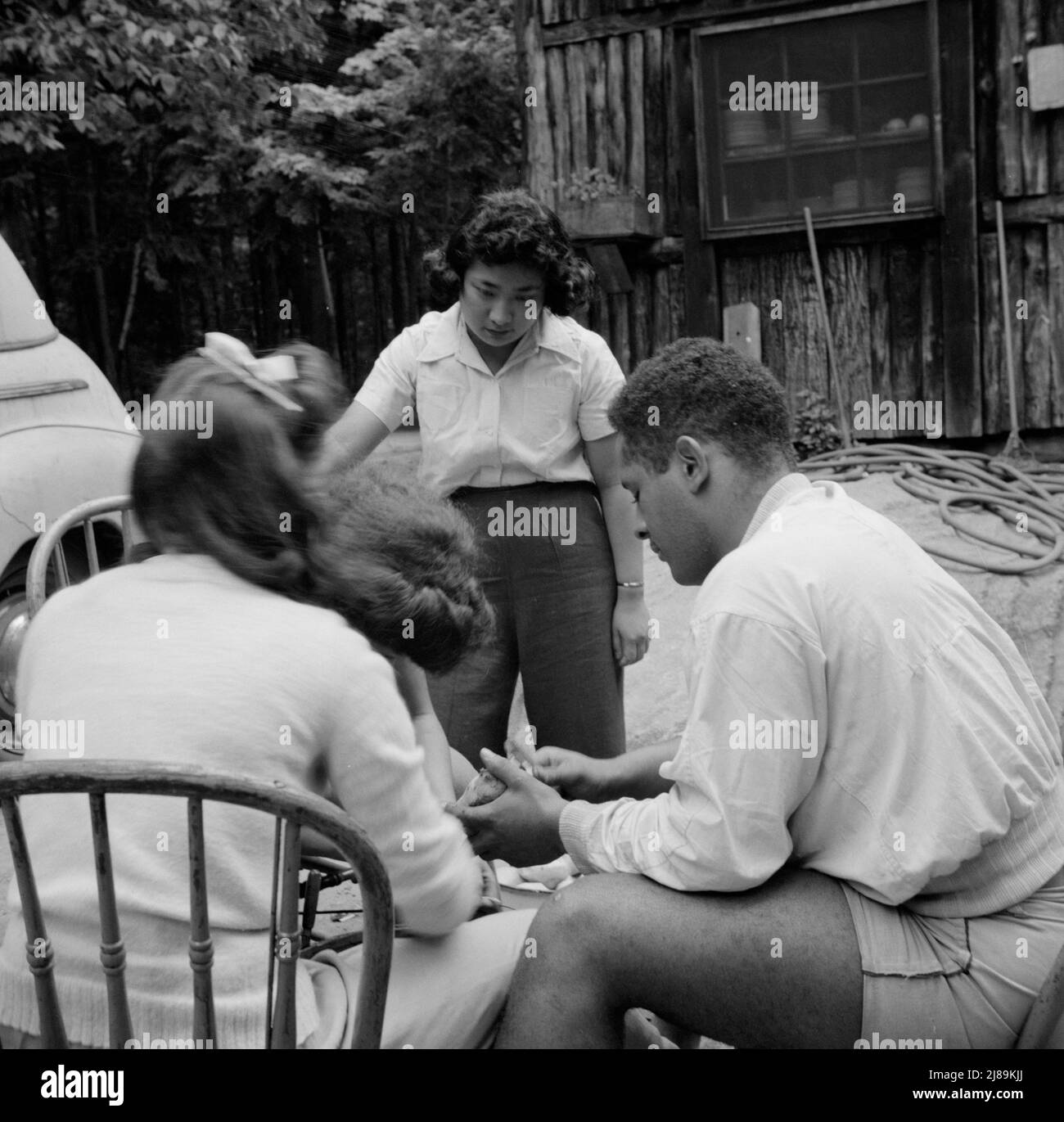 Interracial activities at Camp Ellen Marvin, where children are aided by the Methodist Camp Service. Campers helping with the kitchen work. Arden, New York. Stock Photo