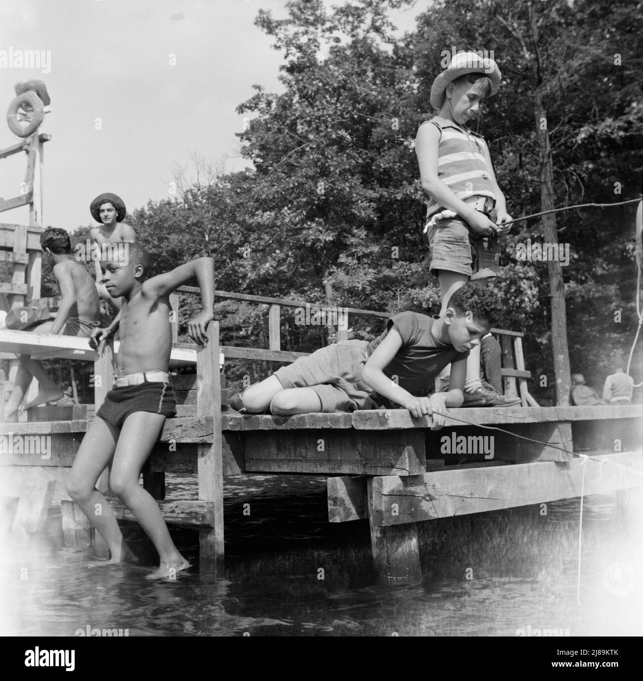 Southfields, New York. Interracial activities at Camp Nathan Hale, where children are aided by the Methodist Camp Service. Fishing is one of the popular activities. Stock Photo
