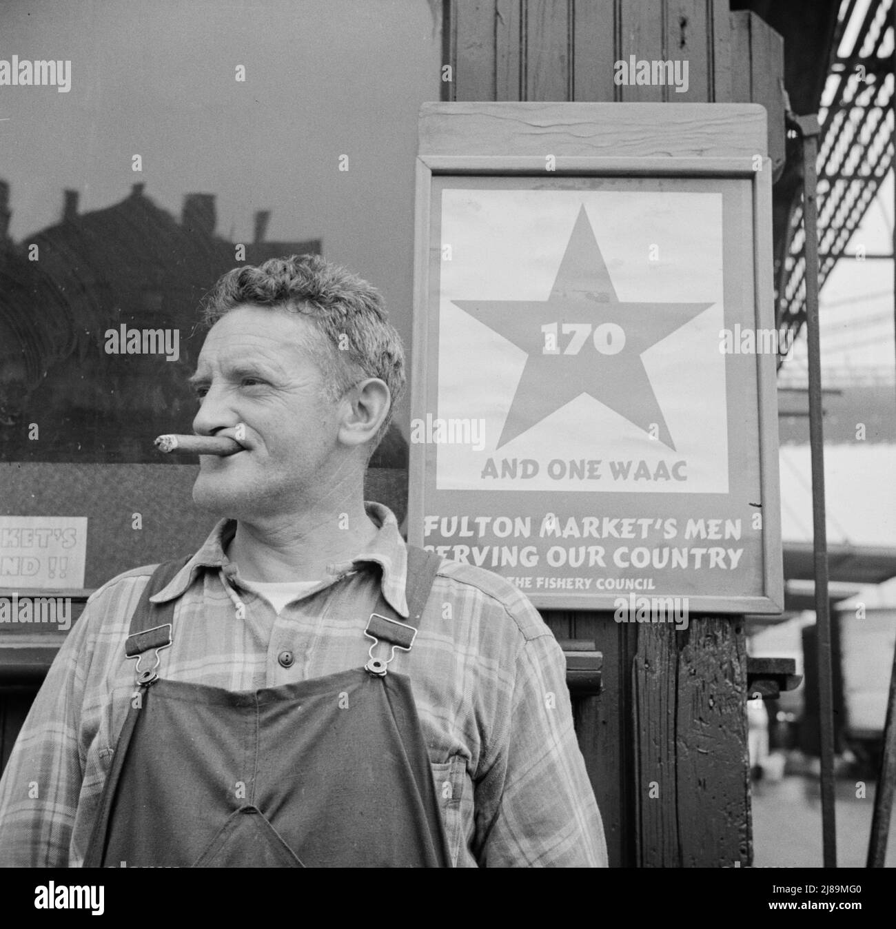 New York, New York. Fulton fish market hooker. [Poster: '170 and one WAAC (Women's Army Auxiliary Corps) Fulton Market's Men Serving Our Country']. Stock Photo