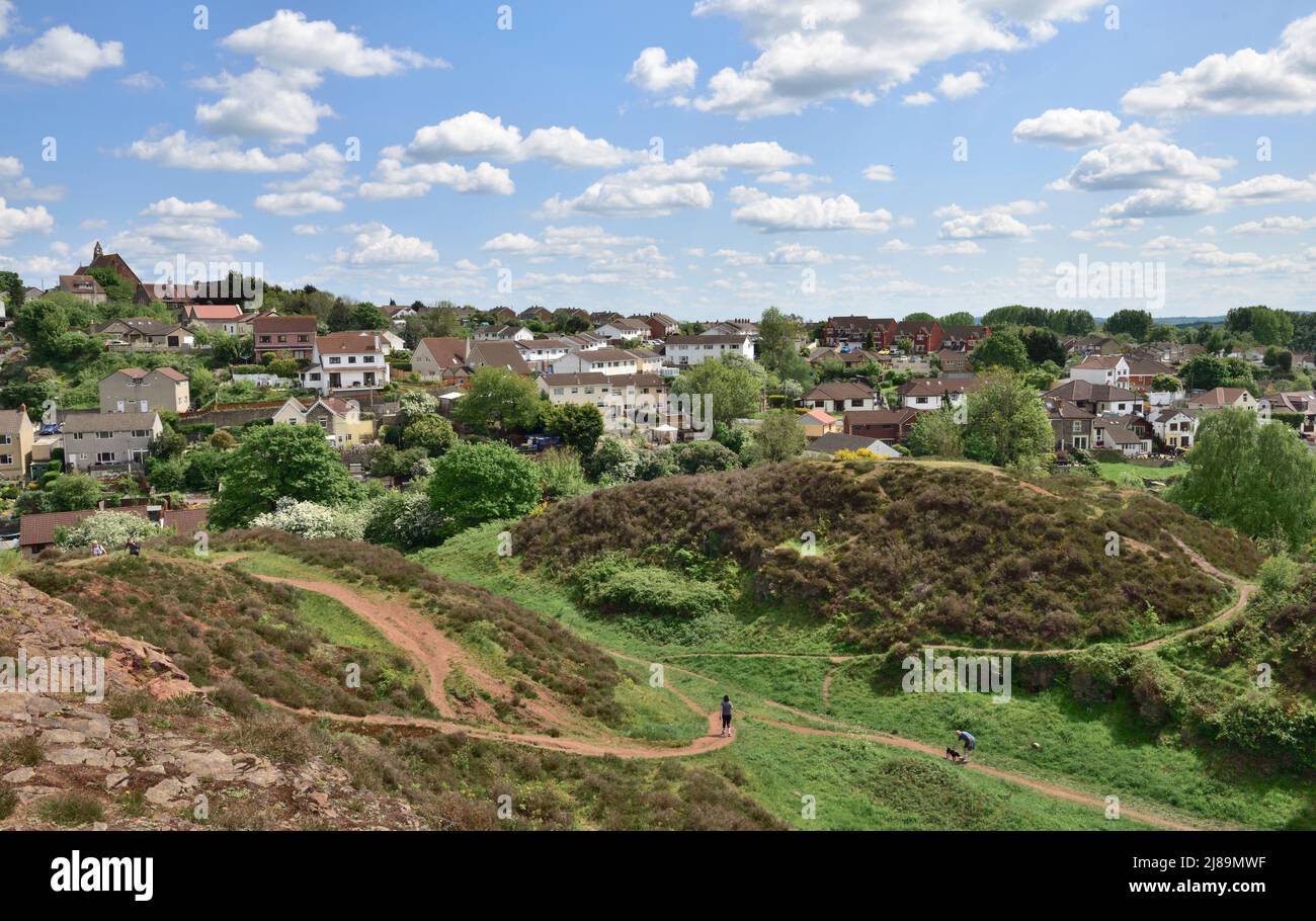 Looking south over trees and houses of Bristol from Troopers' Hill with people walking. Former mining area now park and nature reserve, UK Stock Photo