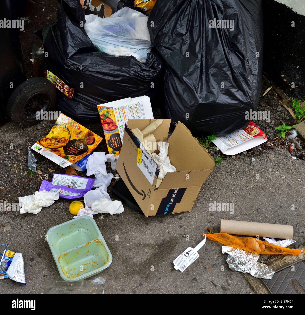 Rubbish bags, litter, dumped on pavement Stock Photo