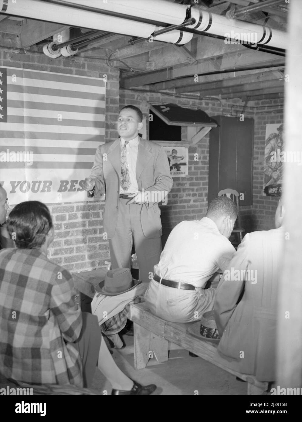 Washington, D.C. Air raid wardens' meeting in zone nine, Southwest area. Mr. Elmer House, federal worker by day and an air raid warden at night, outlining plans for his sector. Stock Photo