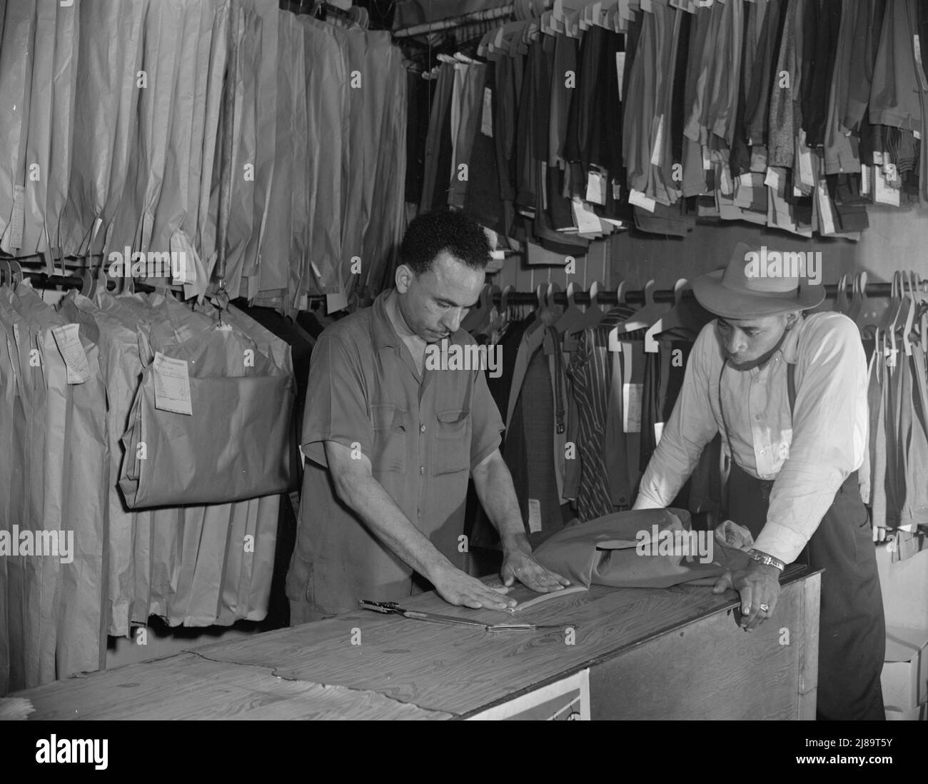 Washington, D.C. A tailor in Frank's cleaning and pressing