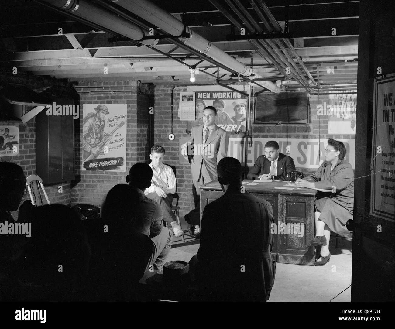 Washington, D.C. Air raid wardens' meeting in zone nine, Southwest area. Elmer House, federal worker by day and an air raid warden at night, outlining plans for his sector. Stock Photo
