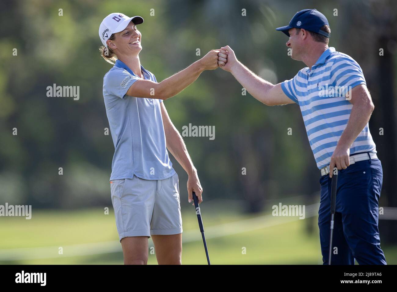 BANG KAPONG THAILAND - May 13: Anne Van Dam of The Netherlands shares a box  with amateur James Davies-Yandel after making birdie on hole 18 during the  second round of the Aramco