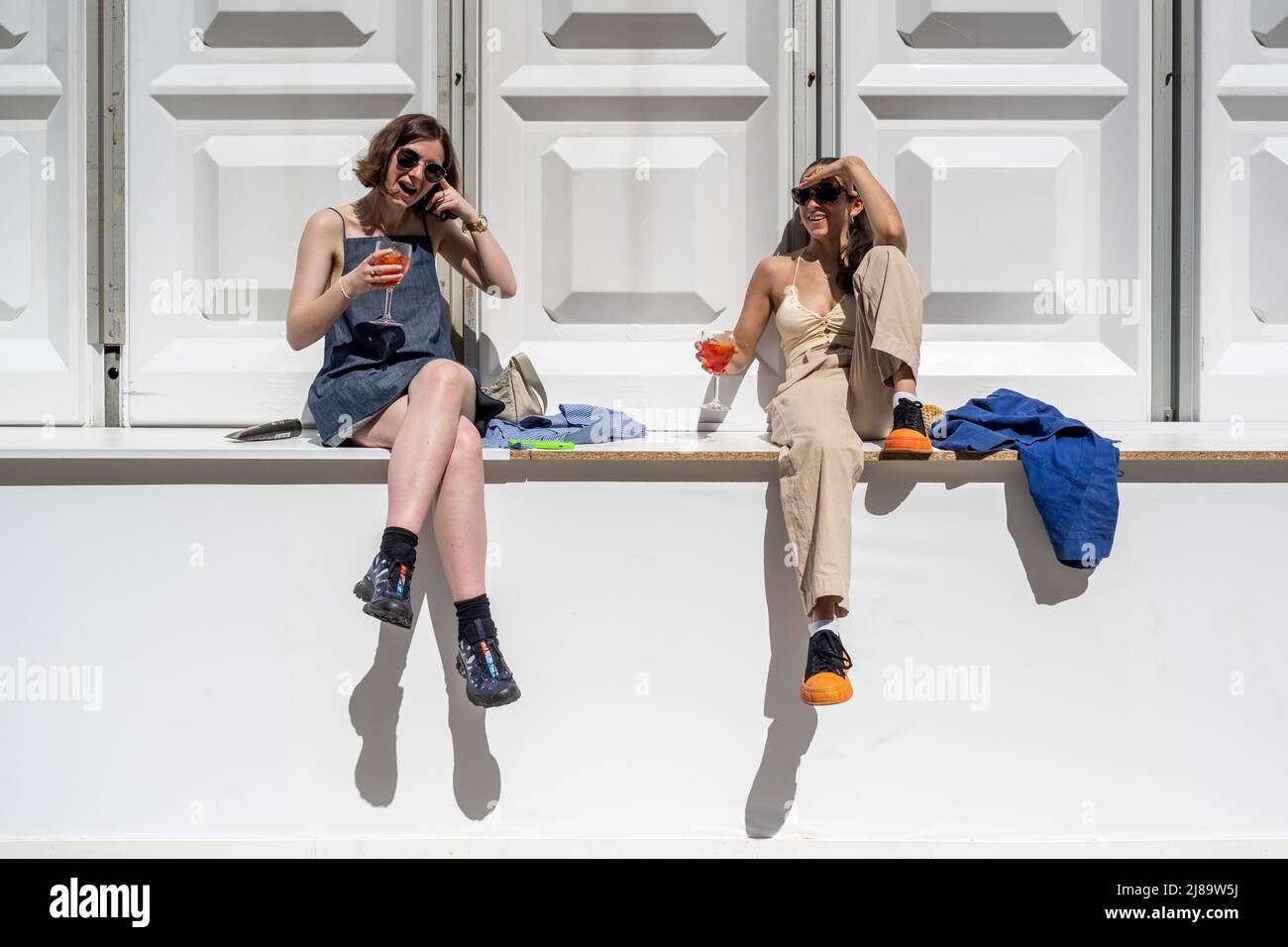 London, UK.  14 May 2022.  UK Weather – Visitors take a break to enjoy a drink in the sunshine during their visit to Photo London at Somerset House.  The annual photography fair at Somerset House celebrates photography from the vintage to modern alongside a selection of the world’s leading photography dealers and galleries.  A public programme of talks, tours and more run throughout the show 12 to 14 May 2022.  Temperatures in the capital are forecast to rise to 22C.  Credit: Stephen Chung / Alamy Live News Stock Photo