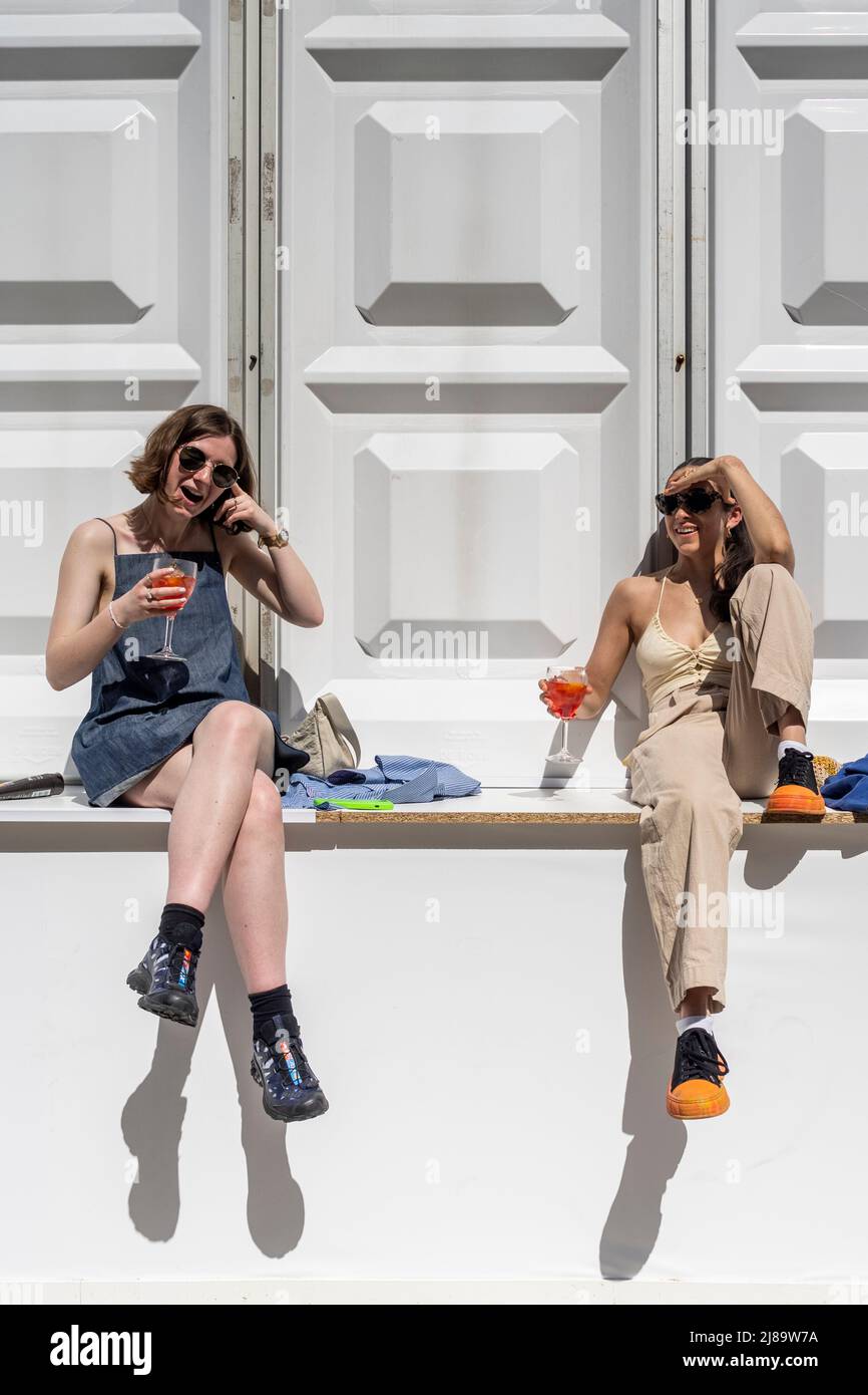 London, UK.  14 May 2022.  UK Weather – Visitors take a break to enjoy a drink in the sunshine during their visit to Photo London at Somerset House.  The annual photography fair at Somerset House celebrates photography from the vintage to modern alongside a selection of the world’s leading photography dealers and galleries.  A public programme of talks, tours and more run throughout the show 12 to 14 May 2022.  Temperatures in the capital are forecast to rise to 22C.  Credit: Stephen Chung / Alamy Live News Stock Photo