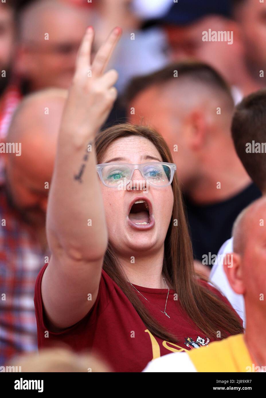 14th May 2022 ; Wembley Stadium, London England; FA Cup Final, Chelsea versus Liverpool: Liverpool fan gesturing rudely as the national anthem of the United Kingdom is played Stock Photo