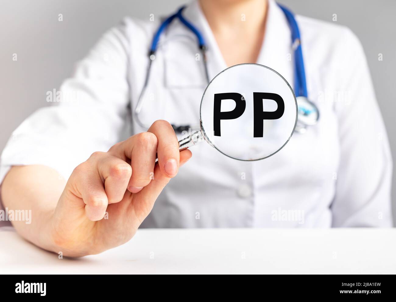 PP vitamin, word acronym through magnifying glass. High quality photo Stock Photo