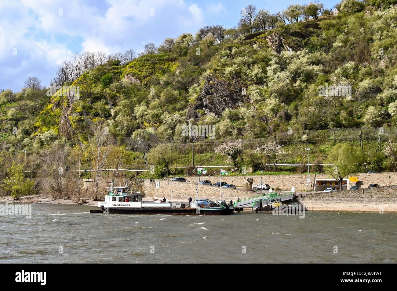 Boppard, Germany - April 2022: Small car ferry being loaded in Boppard, which takes pedestrians and cars over the River Rhine Stock Photo