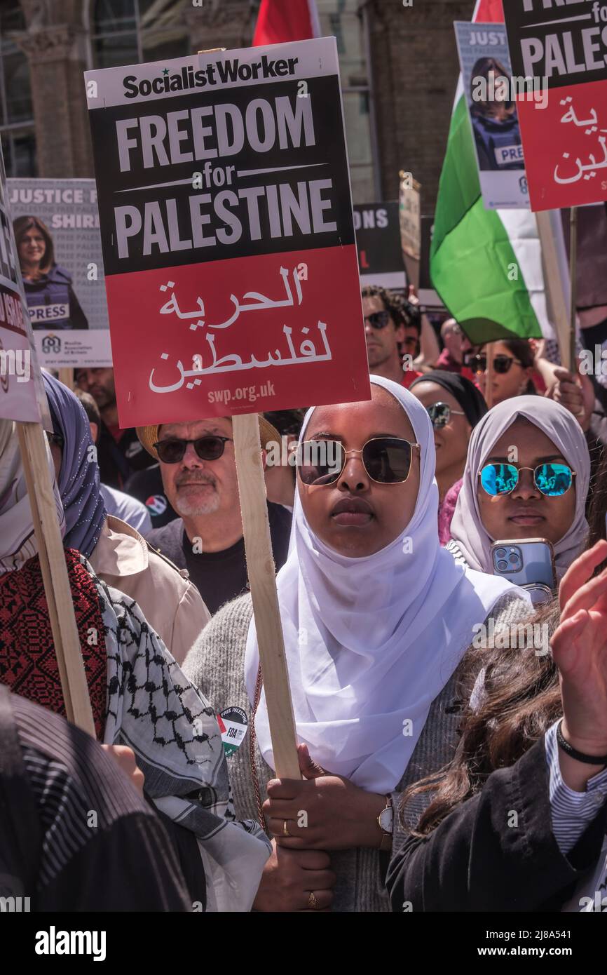 London, UK. 14 May 2022. People march from the BBC to a rally at Downing St against 74 years of Israel's increasing human rights abuse against Palestinians since over 750,000 were displaced from their homes by Zionist Israeli forces. The situation in Israel is now widely recognised internationally as apartheid. Marchers express shock at the attack on the pall-bearers at the funeral of journalist Shireen Abu Akleh, shot in cold blood by Israeli forces. Peter Marshall Alamy Live News Stock Photo