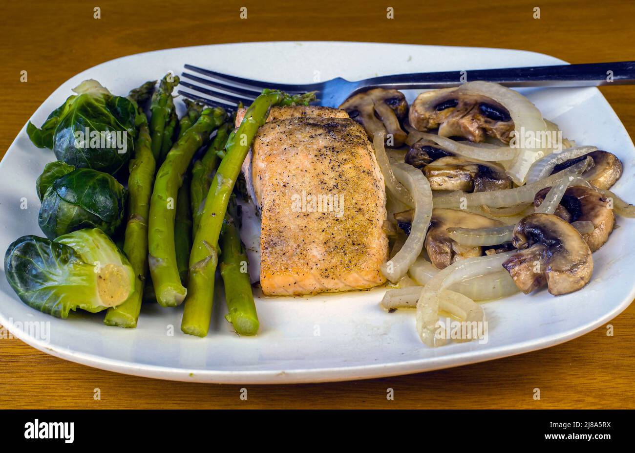 season baked salmon with asparagus and brussel sprouts Stock Photo Alamy