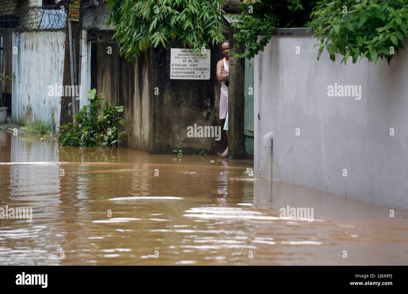 Commuters Make Their Way On A Waterlogged Street After A Heavy Rainfall In Guwahati India On 14