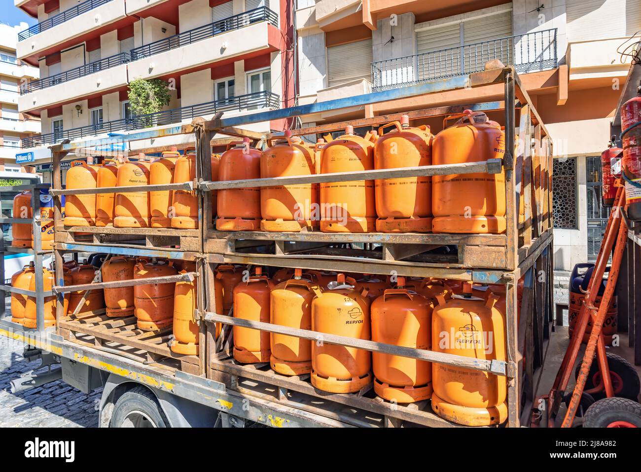 Huelva, Spain - May 10, 2022: A truck delivering orange butane bottles from the Repsol company Stock Photo