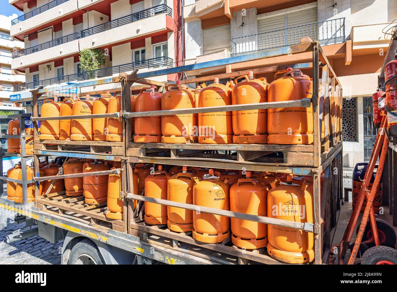 Huelva, Spain - May 10, 2022: A truck delivering orange butane bottles from the Repsol company Stock Photo