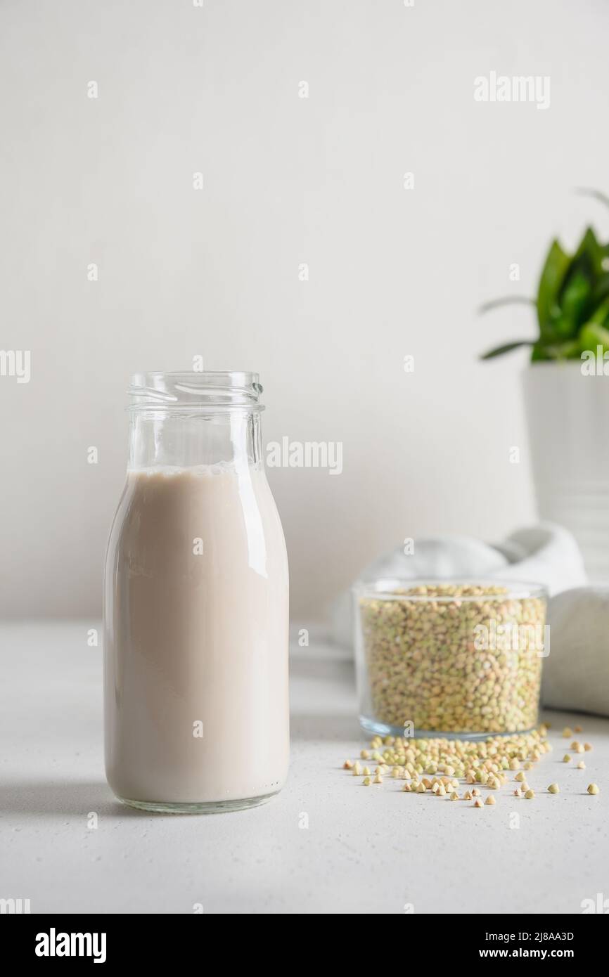 Vegan cereal green buckwheat milk in glass. Close up. Dairy free plant