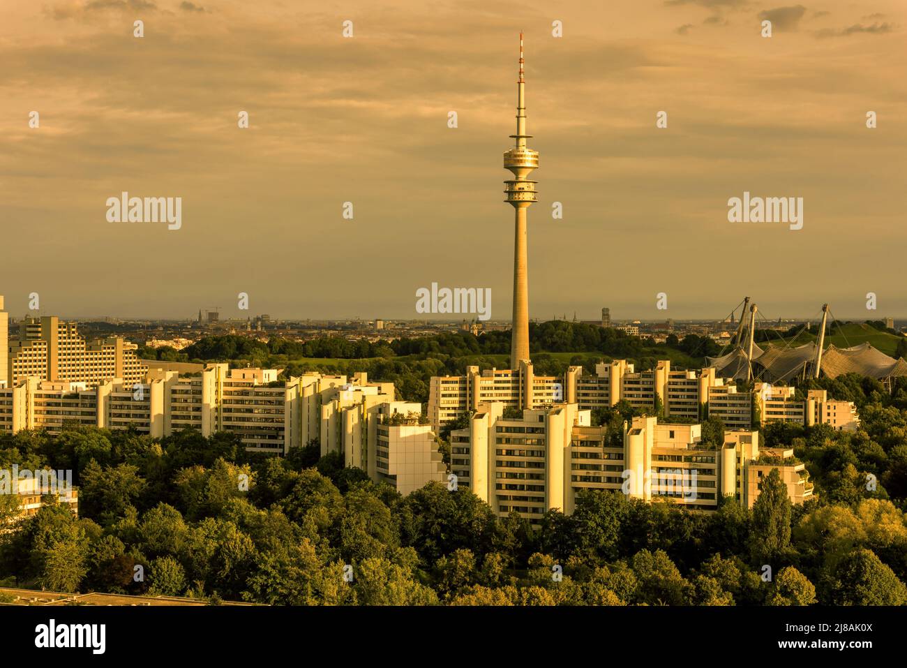 Munich landscape at sunset, Germany, Europe. Panorama of green Olympic Park and Village in summer, Munich skyline with TV Tower. Scenic aerial view of Stock Photo