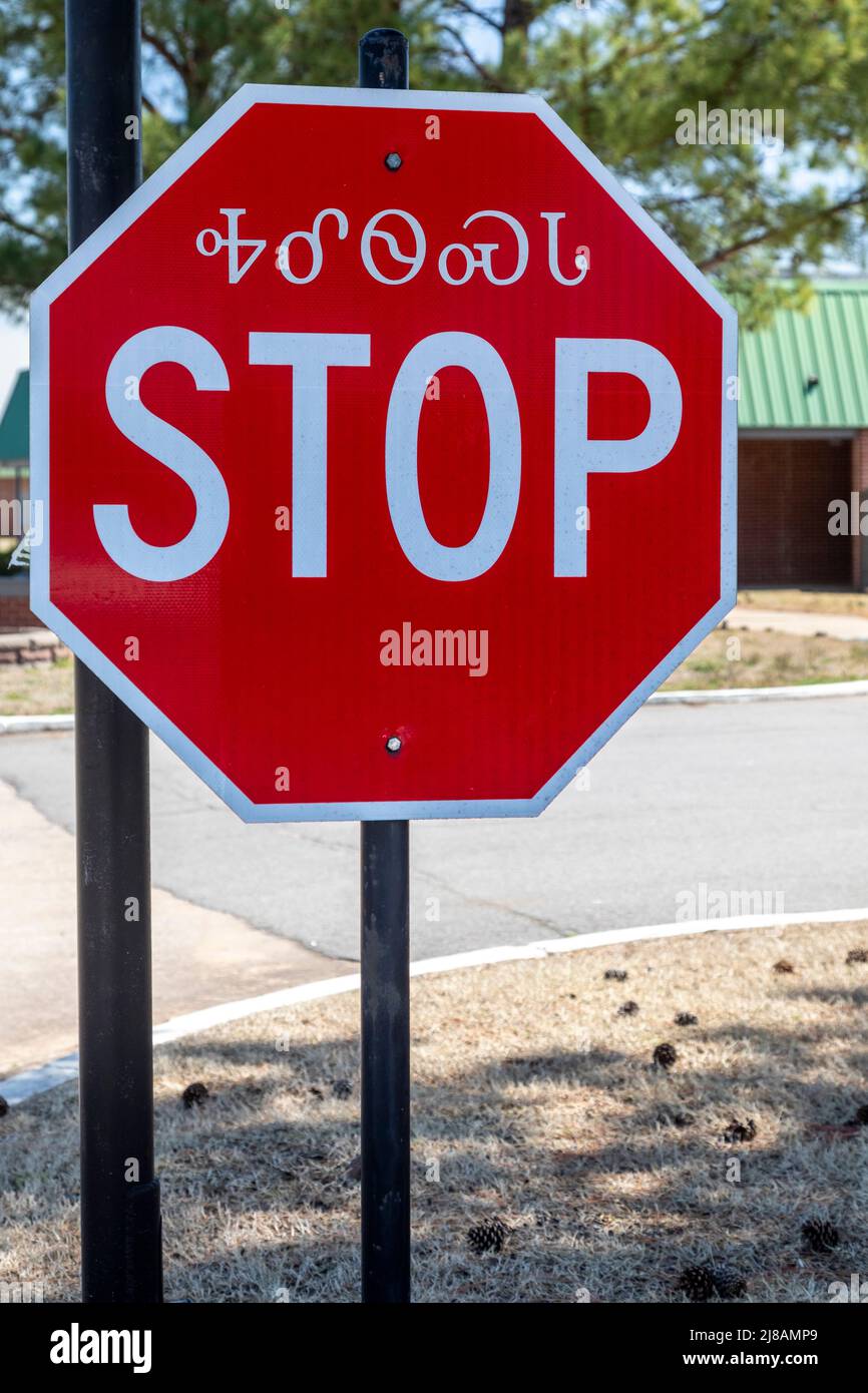 Tahlequah, Oklahoma - A stop sign in English and Cherokee in the northeastern Oklahoma town where the Cherokee Nation has its headquarters. Stock Photo